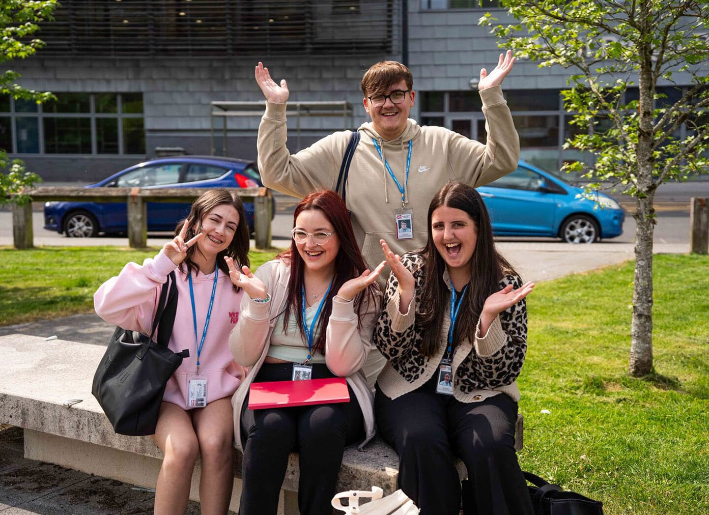 Students smiling and waving hands