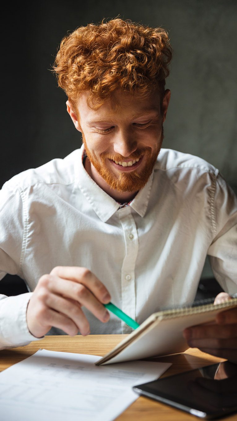 Man writing notes on a notepad
