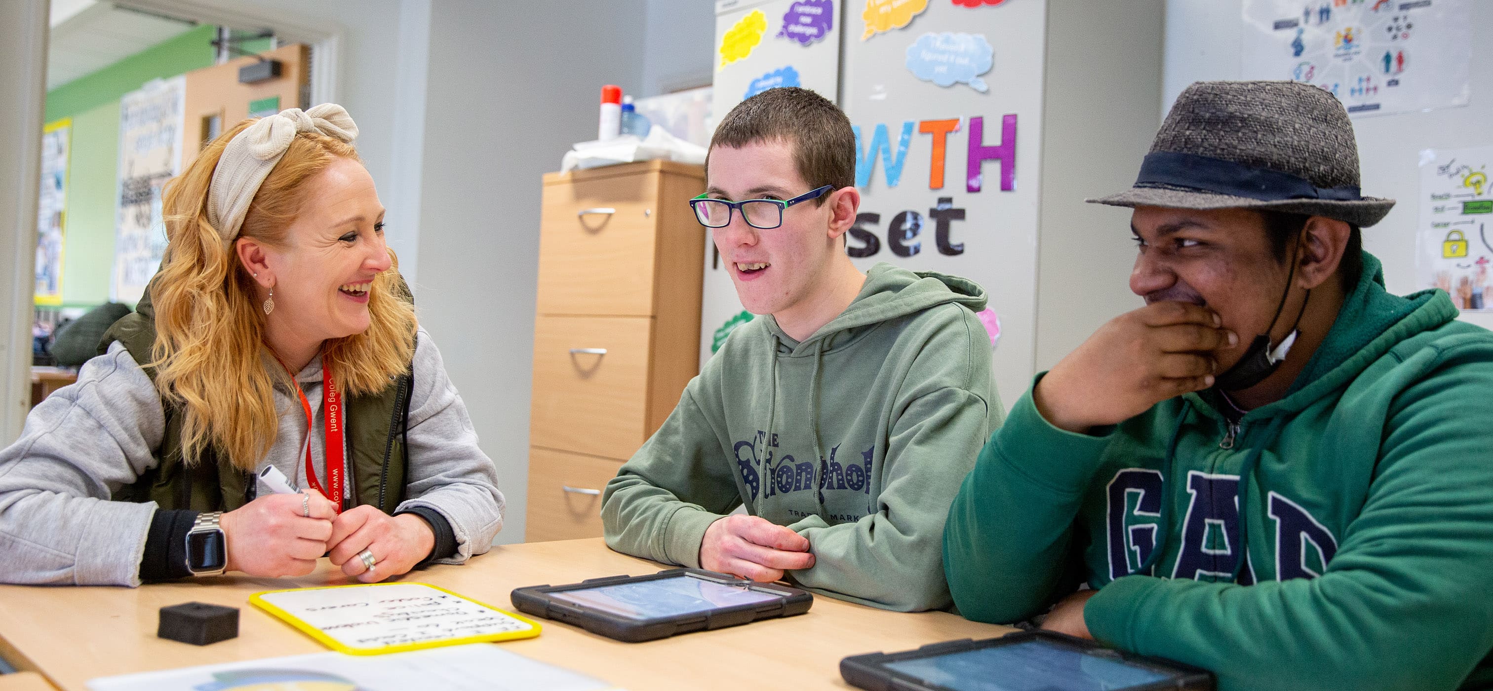 ILS students in class working on tablet devices