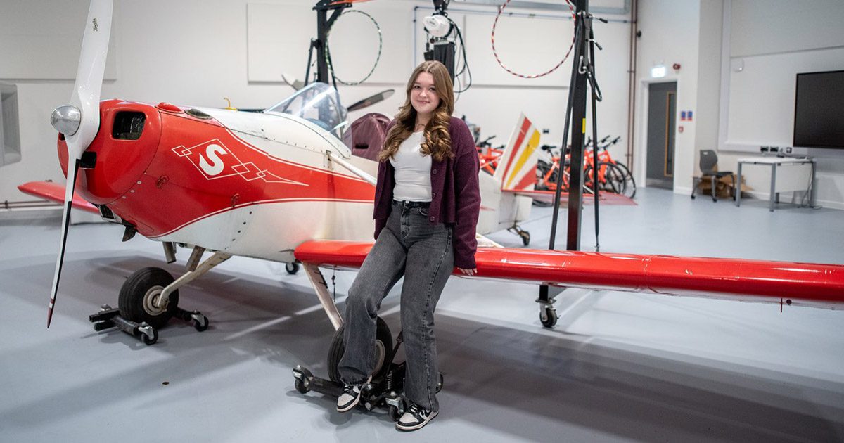 Aimee sat on an aeroplane wing