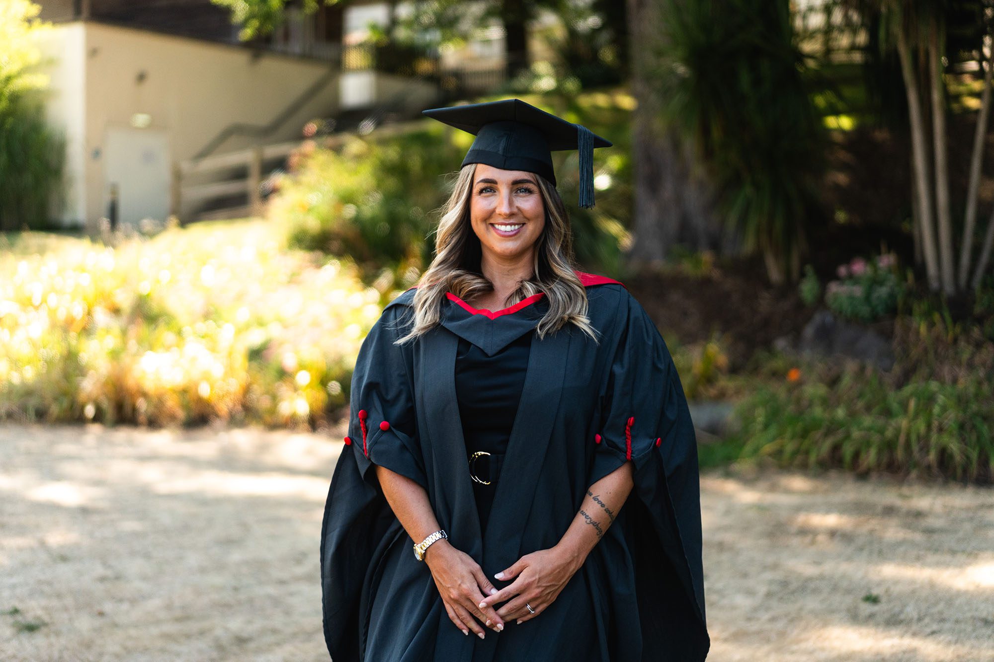 Graduate smiling wearing a cap and gown