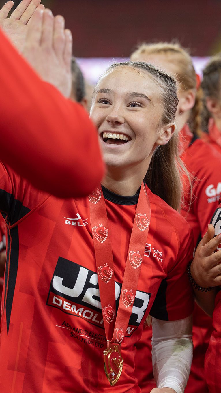 Rugby player Meg celebrating on the pitch